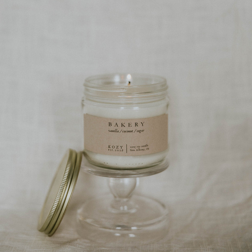 Glass candle with a label on a neutral background