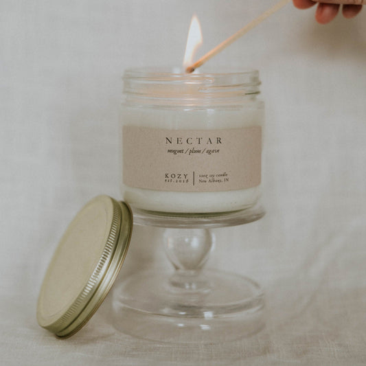 Candle being lit with a match, labeled 'Nectar' on a neutral background
