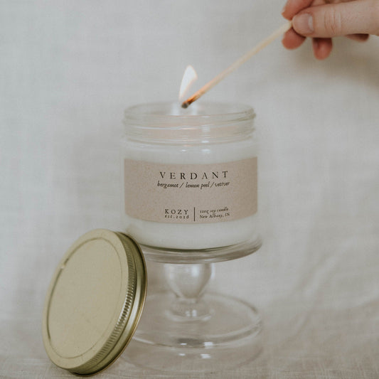 Candle being lit with a match, labeled 'Verdant' on a neutral background
