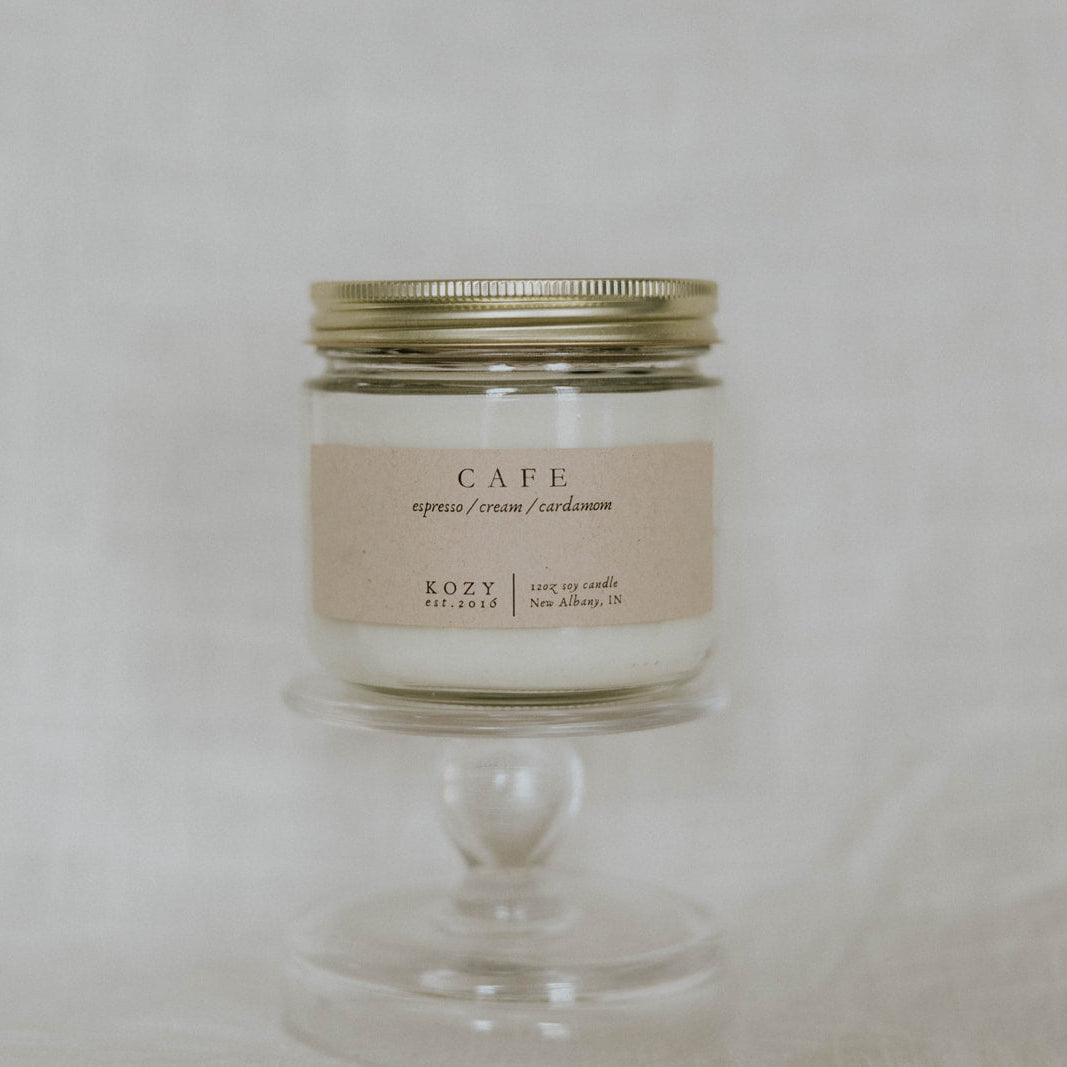 Candle in a glass jar with a metal lid on a neutral background