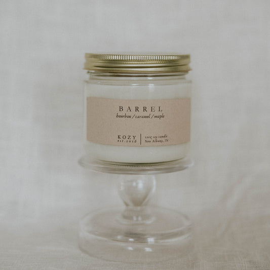 Candle in a glass jar with a metal lid on a white background