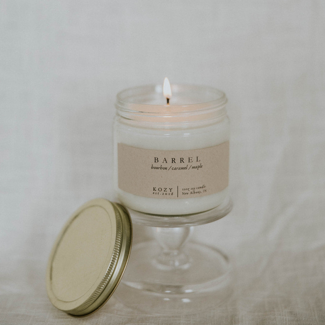 Candle in a glass jar with a lid on a light background