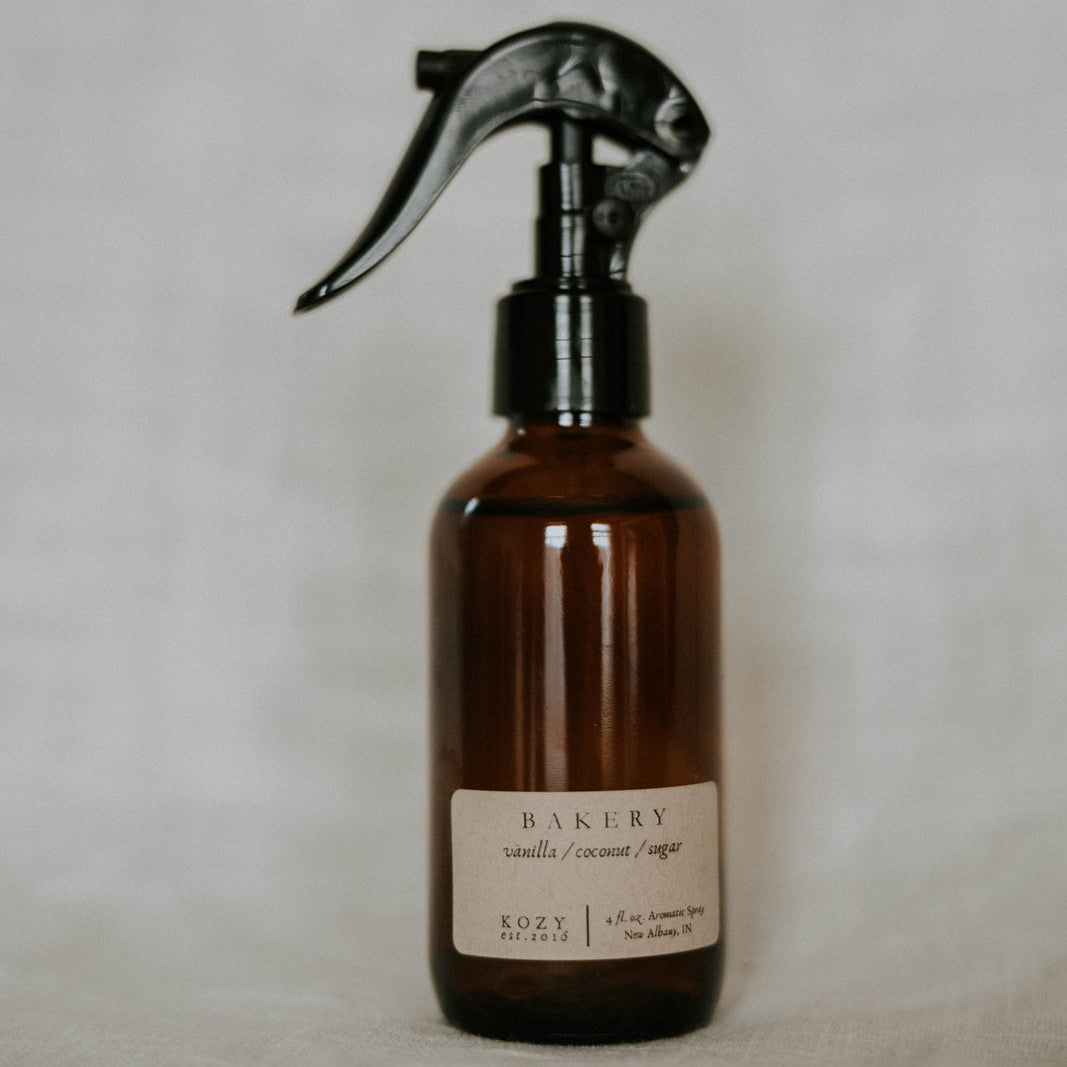 Brown spray bottle with a label on a light gray background