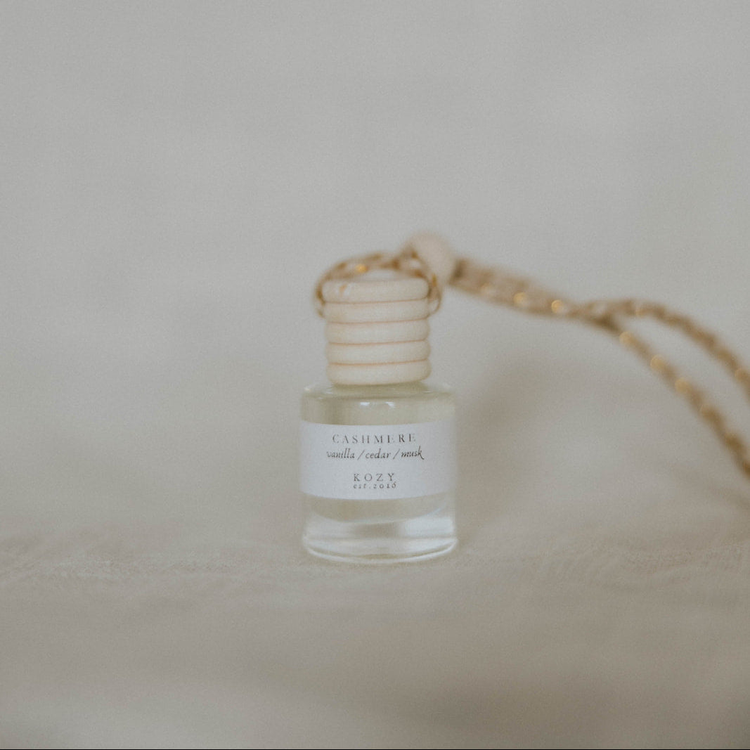 Small hanging car diffuser, scent 'Cashmere', on a beige background