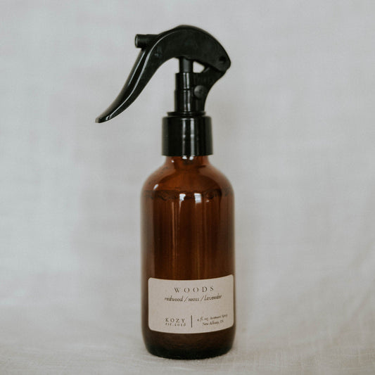 Brown spray bottle with black nozzle on a light gray background